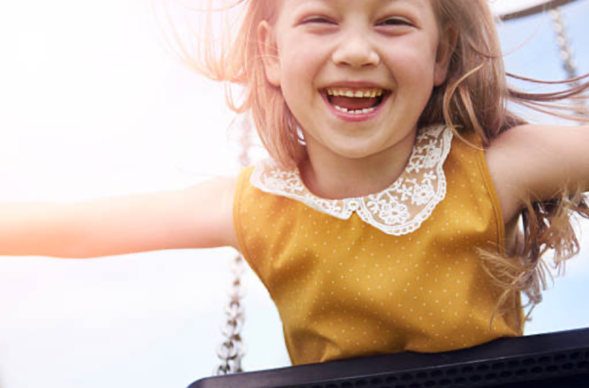 happy little girl smiling in the sun